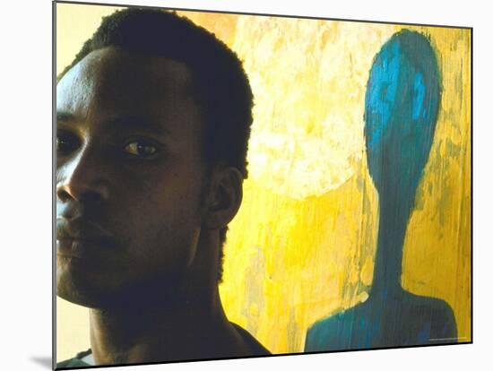 Portrait of Nigerian Artist Erhabor Emokpae Standing Next to One of His Colorful Paintings-Carlo Bavagnoli-Mounted Premium Photographic Print