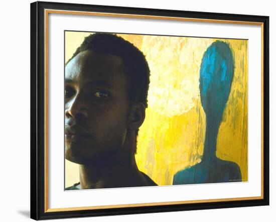 Portrait of Nigerian Artist Erhabor Emokpae Standing Next to One of His Colorful Paintings-Carlo Bavagnoli-Framed Premium Photographic Print