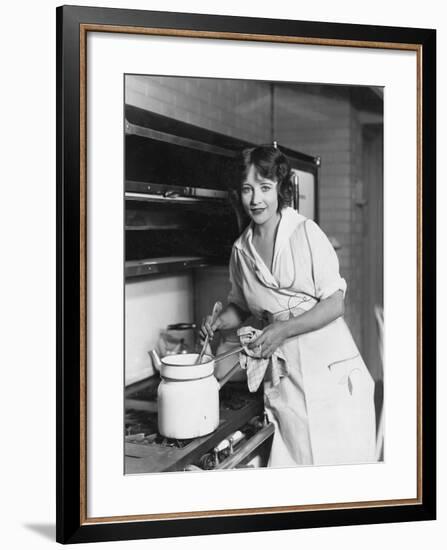 Portrait of Woman Stirring Pot on Stove-null-Framed Photo