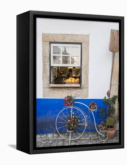 Portugal, Obidos. Cute bicycle planter in front of a bakery in the walled city of Obidos.-Julie Eggers-Framed Premier Image Canvas