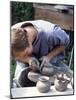 Potter at Work on Wheel at Rustic Fayre, Devon, England, United Kingdom-Ian Griffiths-Mounted Photographic Print