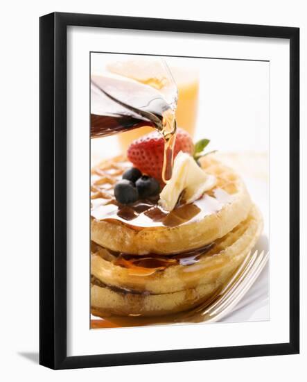 Pouring Maple Syrup over Waffles with Butter and Berries-null-Framed Photographic Print