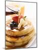 Pouring Maple Syrup over Waffles with Butter and Berries-null-Mounted Photographic Print
