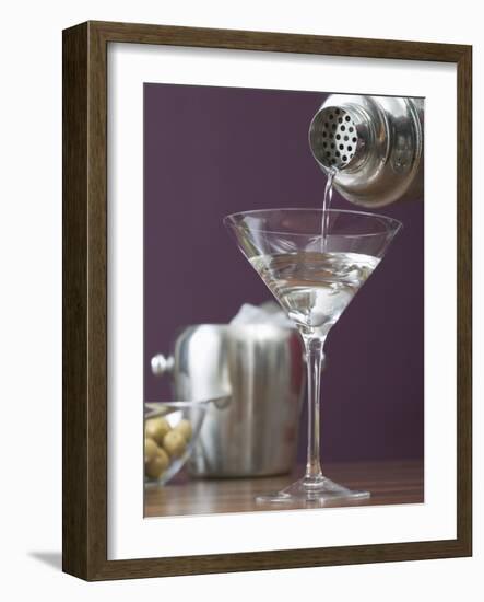 Pouring Martini Out of Cocktail Shaker into Glass-null-Framed Photographic Print