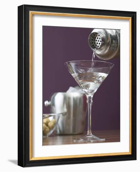 Pouring Martini Out of Cocktail Shaker into Glass-null-Framed Photographic Print