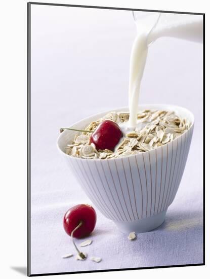 Pouring Milk onto Oat Flakes-null-Mounted Photographic Print