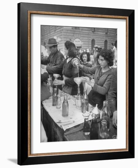 Pouring Olive Oil in Buyers' Bottles in Black Market-Alfred Eisenstaedt-Framed Photographic Print