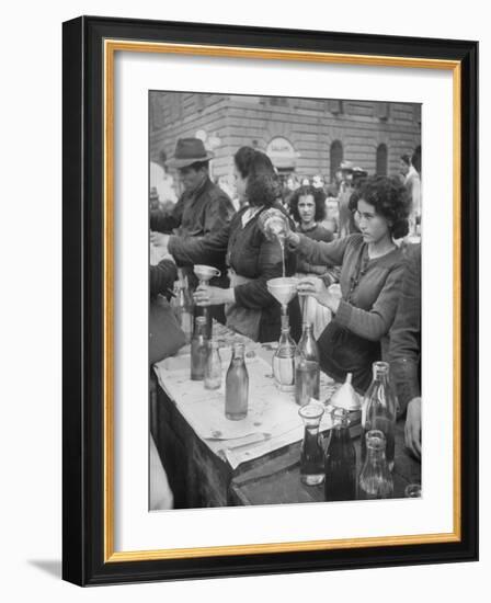 Pouring Olive Oil in Buyers' Bottles in Black Market-Alfred Eisenstaedt-Framed Photographic Print