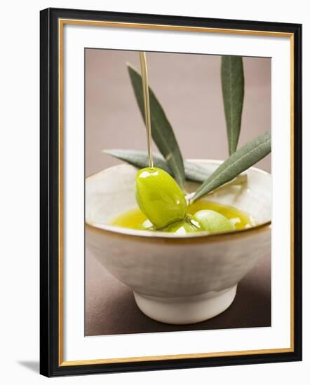 Pouring Olive Oil Over Olive Sprig with Green Olives-null-Framed Photographic Print