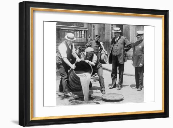 Pouring Out Illegal Alcohol into a Sewer-null-Framed Art Print