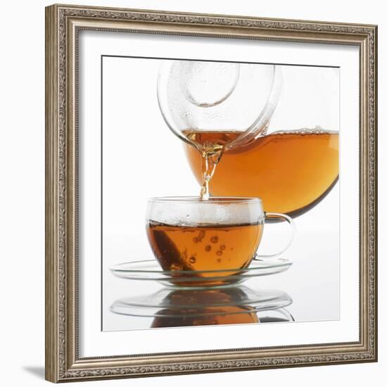 Pouring Tea into a Glass Cup-Alexander Feig-Framed Photographic Print