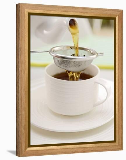 Pouring Tea Through a Tea Strainer-Winfried Heinze-Framed Premier Image Canvas