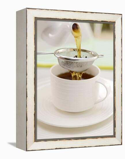 Pouring Tea Through a Tea Strainer-Winfried Heinze-Framed Premier Image Canvas