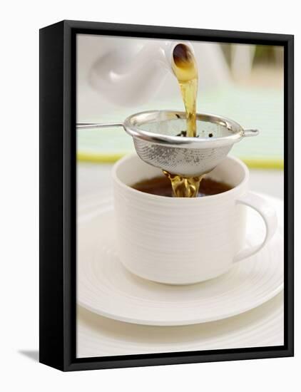 Pouring Tea Through a Tea Strainer-Winfried Heinze-Framed Premier Image Canvas