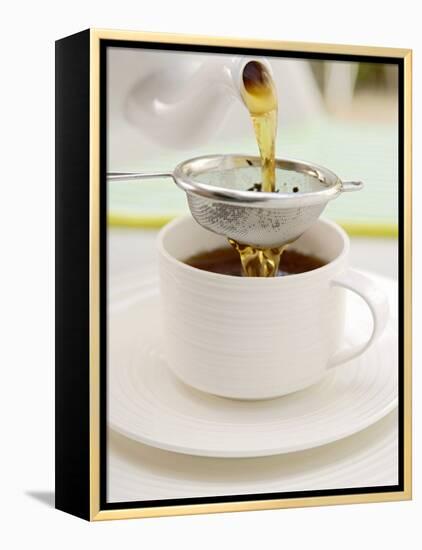 Pouring Tea Through a Tea Strainer-Winfried Heinze-Framed Premier Image Canvas