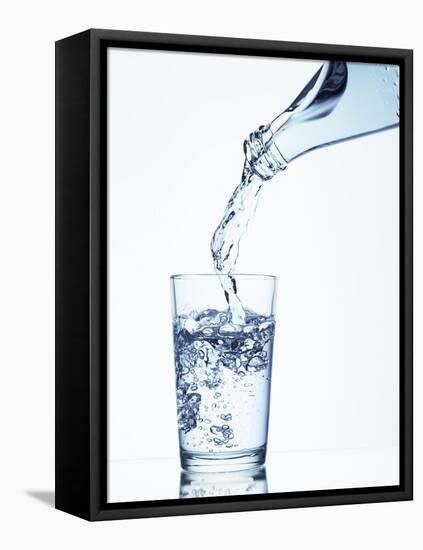 Pouring Water from a Bottle into a Glass-Petr Gross-Framed Premier Image Canvas