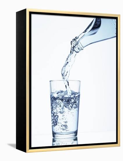 Pouring Water from a Bottle into a Glass-Petr Gross-Framed Premier Image Canvas