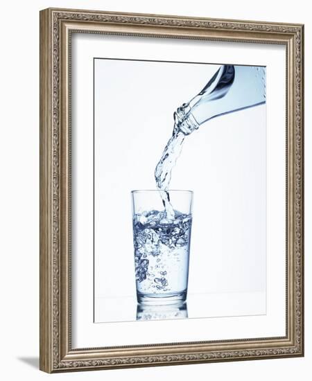 Pouring Water from a Bottle into a Glass-Petr Gross-Framed Photographic Print