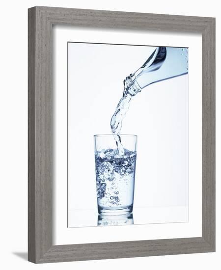 Pouring Water from a Bottle into a Glass-Petr Gross-Framed Photographic Print