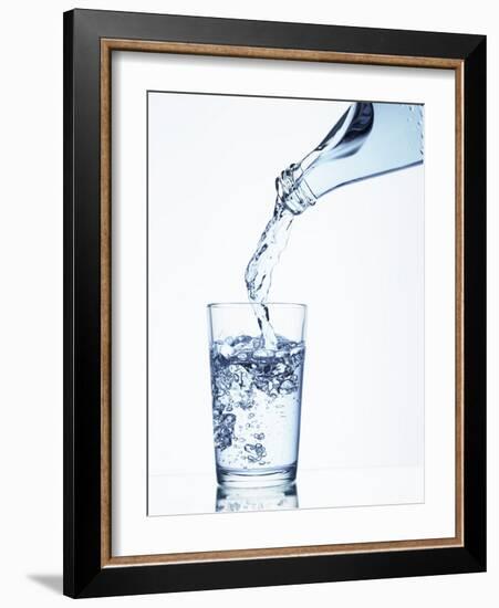 Pouring Water from a Bottle into a Glass-Petr Gross-Framed Photographic Print