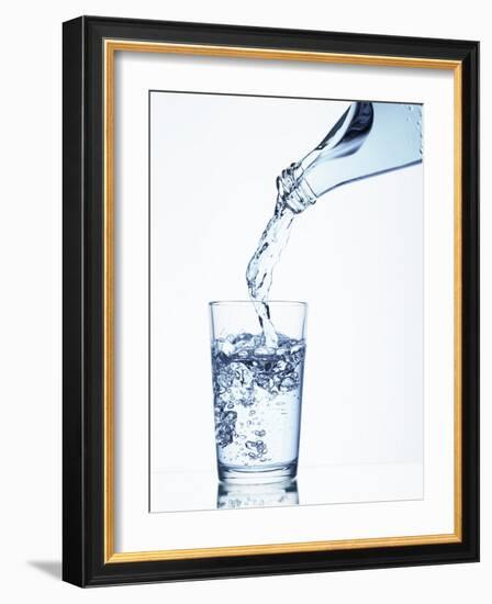 Pouring Water from a Bottle into a Glass-Petr Gross-Framed Photographic Print