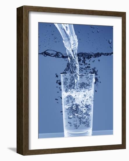 Pouring Water from a Bottle into a Glass-Petr Gross-Framed Photographic Print