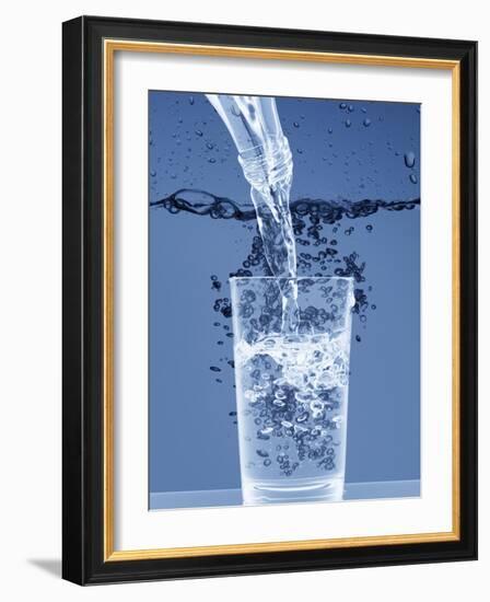 Pouring Water from a Bottle into a Glass-Petr Gross-Framed Photographic Print