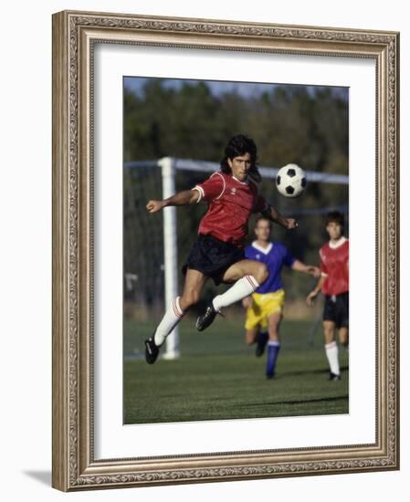 Powerful Leaping Soccer Player-null-Framed Photographic Print