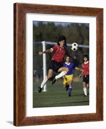 Powerful Leaping Soccer Player-null-Framed Photographic Print