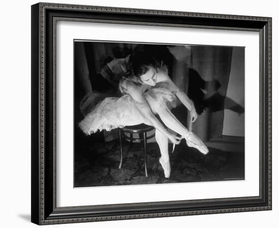 Premier Ballerina Semionova Tying Her Toe Shoe Before a Performance at the Great Theater-Margaret Bourke-White-Framed Photographic Print