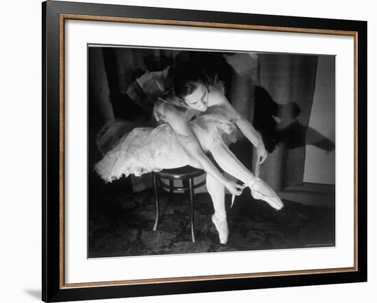 Premier Ballerina Semionova Tying Her Toe Shoe Before a Performance at the Great Theater-Margaret Bourke-White-Framed Photographic Print