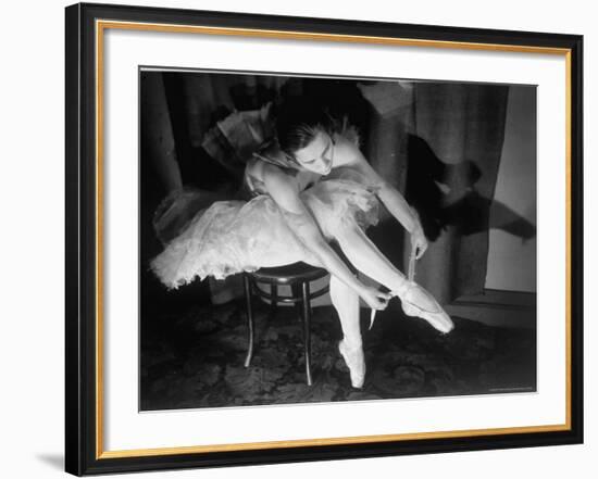 Premier Ballerina Semionova Tying Her Toe Shoe Before a Performance at the Great Theater-Margaret Bourke-White-Framed Photographic Print