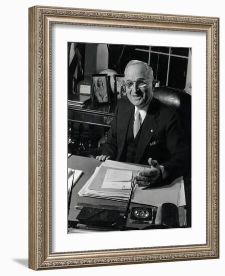 Pres. Harry S. Truman Seated at His Desk in the White House, Family Photographs on Table Behind Him-Gjon Mili-Framed Photographic Print