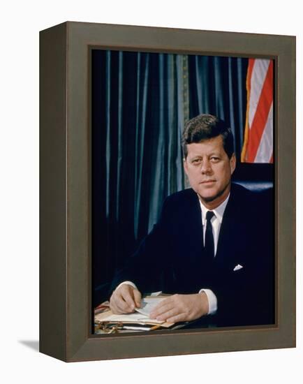 Pres. John F. Kennedy Sitting at His Desk, with Flag in Bkgrd-Alfred Eisenstaedt-Framed Premier Image Canvas