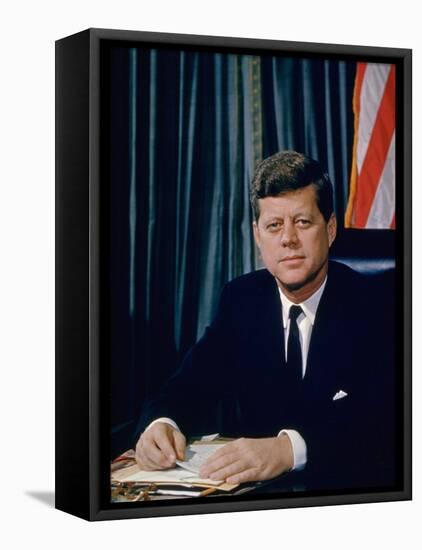 Pres. John F. Kennedy Sitting at His Desk, with Flag in Bkgrd-Alfred Eisenstaedt-Framed Premier Image Canvas