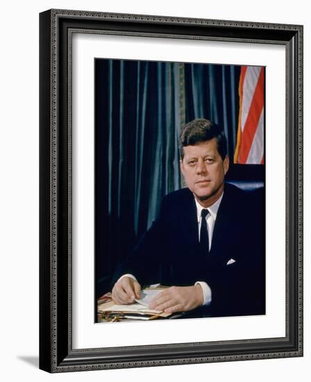 Pres. John F. Kennedy Sitting at His Desk, with Flag in Bkgrd-Alfred Eisenstaedt-Framed Photographic Print