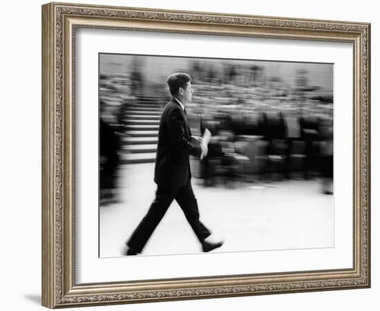 Pres John Kennedy Walking Fast after Press Conference in State Department Auditorium, Mar 11, 1963-null-Framed Photo