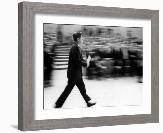 Pres John Kennedy Walking Fast after Press Conference in State Department Auditorium, Mar 11, 1963-null-Framed Photo