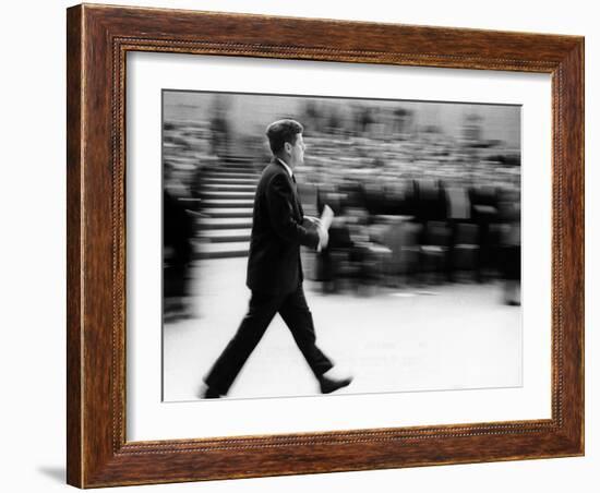 Pres John Kennedy Walking Fast after Press Conference in State Department Auditorium, Mar 11, 1963-null-Framed Photo