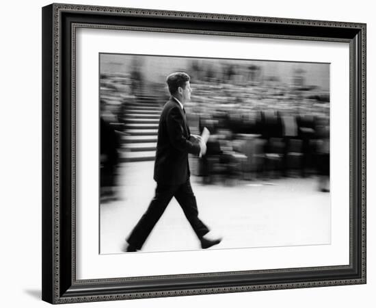 Pres John Kennedy Walking Fast after Press Conference in State Department Auditorium, Mar 11, 1963-null-Framed Photo