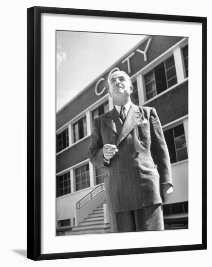 President and Director of Coty Perfumes Andre Lavault in Front of Building Holding Cigarette-Hans Wild-Framed Premium Photographic Print