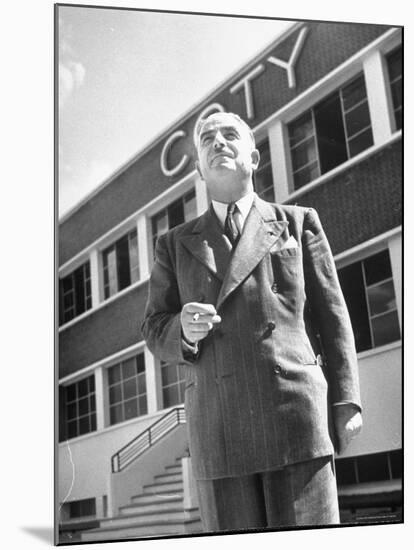 President and Director of Coty Perfumes Andre Lavault in Front of Building Holding Cigarette-Hans Wild-Mounted Premium Photographic Print