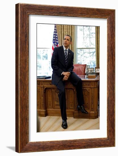 President Barack Obama Sits on the Edge of the Resolute Desk in the Oval Office, April 30, 2010-null-Framed Photo