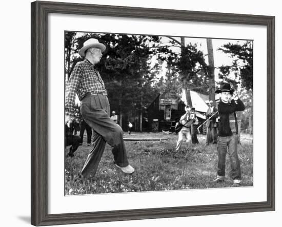 President Eisenhower Adds a Little 'Body English' to David Eisenhower's Golf Swing-null-Framed Photo