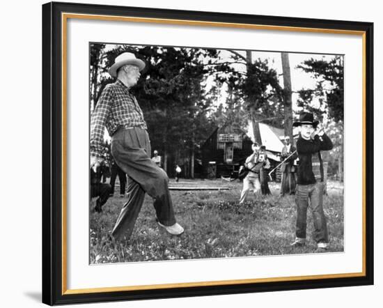 President Eisenhower Adds a Little 'Body English' to David Eisenhower's Golf Swing-null-Framed Photo