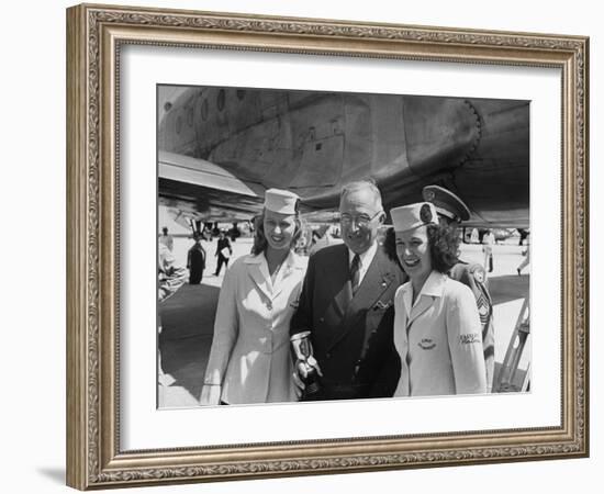 President Harry S. Truman Standing Near a Plane Flanked by Stewardesses-null-Framed Photographic Print