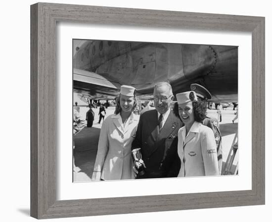 President Harry S. Truman Standing Near a Plane Flanked by Stewardesses-null-Framed Photographic Print