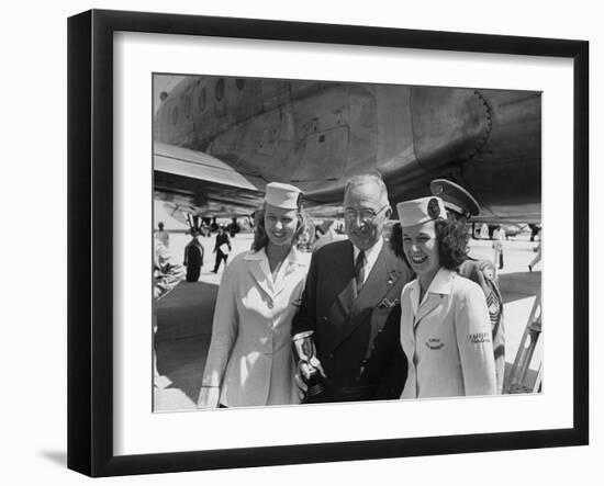 President Harry S. Truman Standing Near a Plane Flanked by Stewardesses-null-Framed Photographic Print