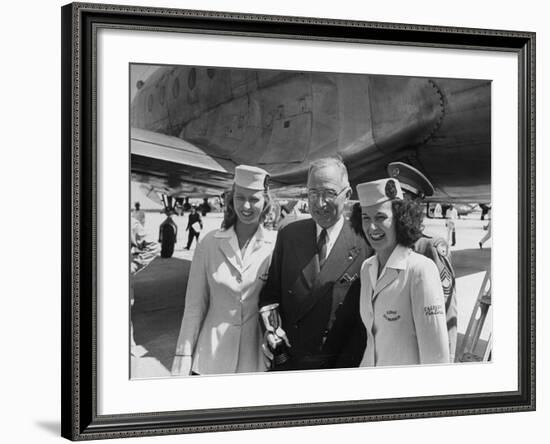 President Harry S. Truman Standing Near a Plane Flanked by Stewardesses-null-Framed Photographic Print