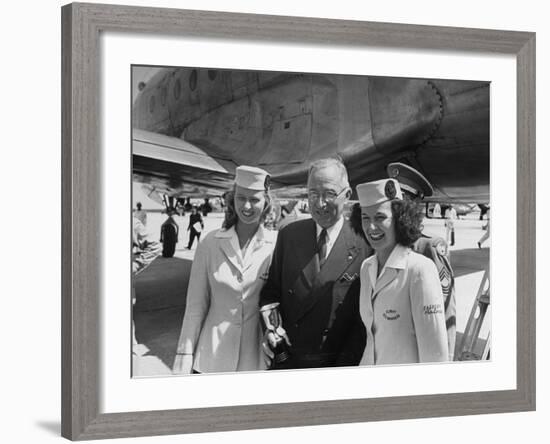 President Harry S. Truman Standing Near a Plane Flanked by Stewardesses-null-Framed Photographic Print